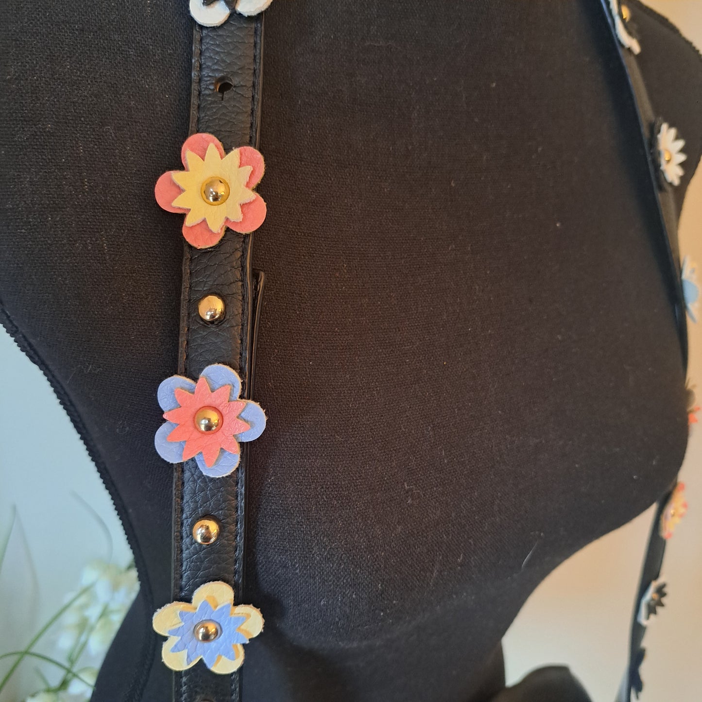 IMO Black faux leather crossbody with flowers on shoulder strap